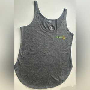 Women’s grey racerback tank top featuring the logo for Studio 13.  Size XS or S.